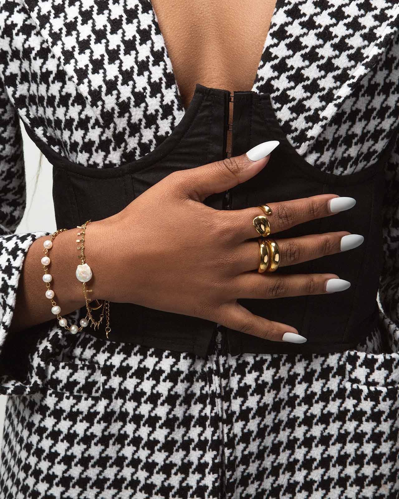 image of a girls hand, wearing rings and bracelets